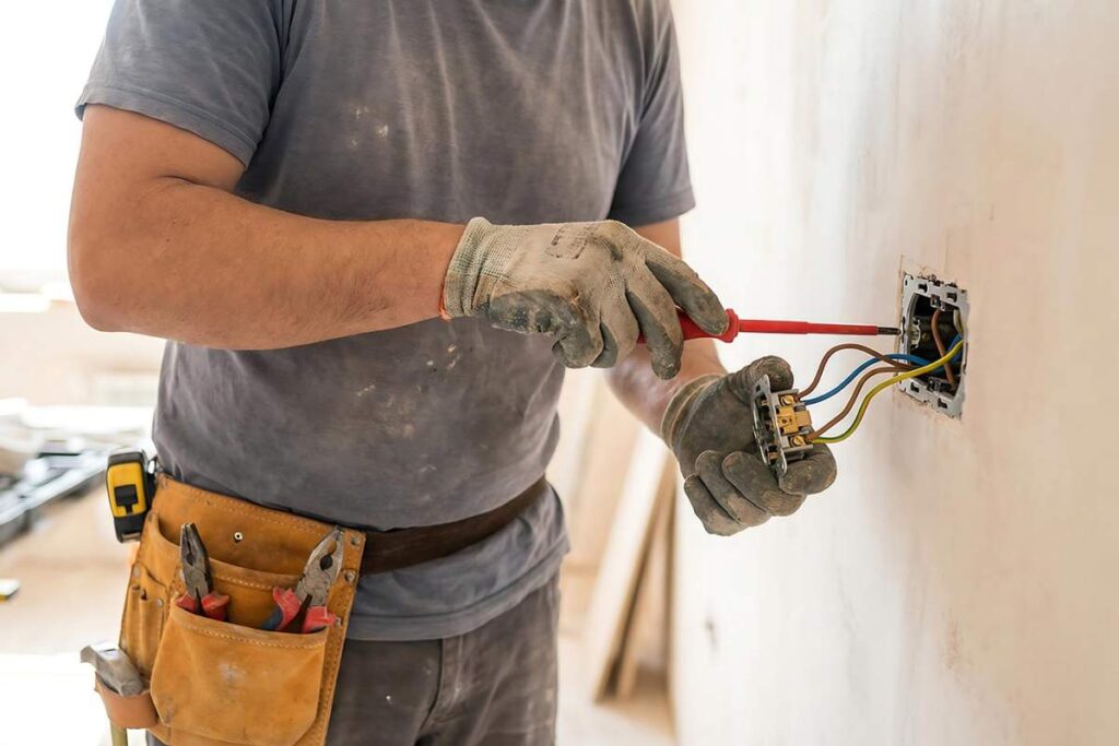 Workers review plans in a bright commercial interior with ventilation equipment and daylight-focused design.